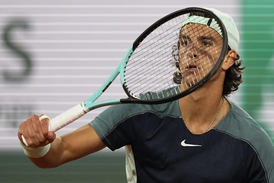 Italy's Lorenzo Musetti gestures as he plays Greece's Stefanos Tsitsipas during their first round match of the French Open tennis tournament at the Roland Garros stadium Tuesday, May 24, 2022 in Paris. (AP Photo/Michel Euler)