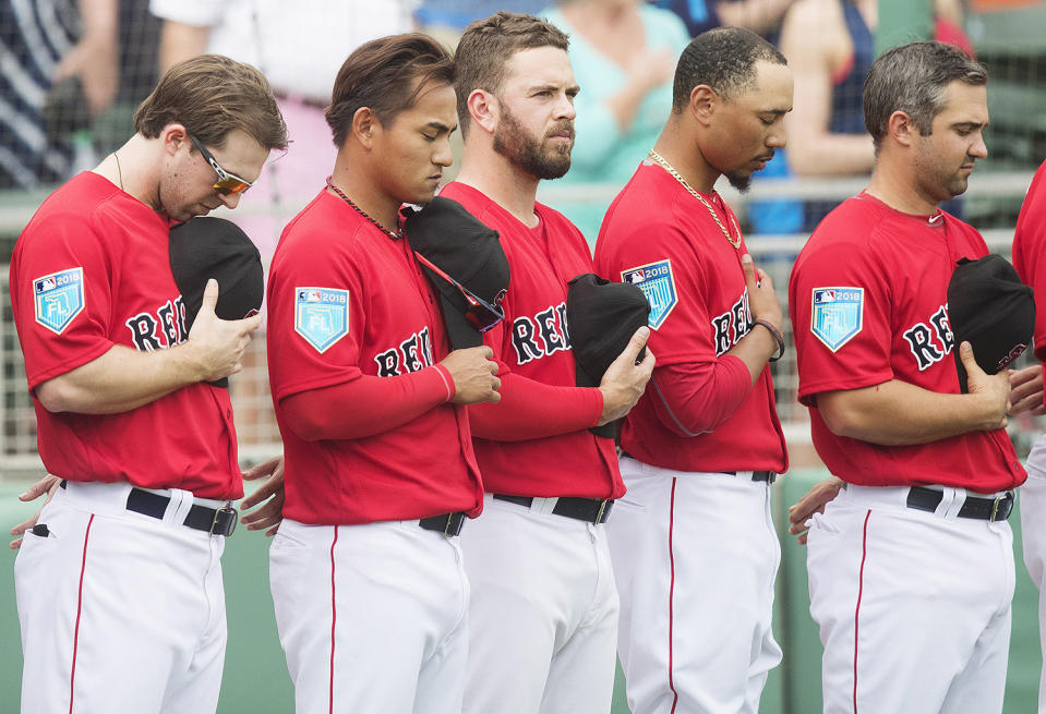 <p>Boston Red Sox players stop for a moment of silence honoring the victims of the shooting at Marjory Stoneman Douglas High School last week, prior to their spring training game against the Minnesota Twins at JetBlue Park in Flort Myers, Fla., on Feb. 23, 2018. (Photo: Kinfay Moroti/The News-Press via USA TODAY NETWORK/Reuters) </p>