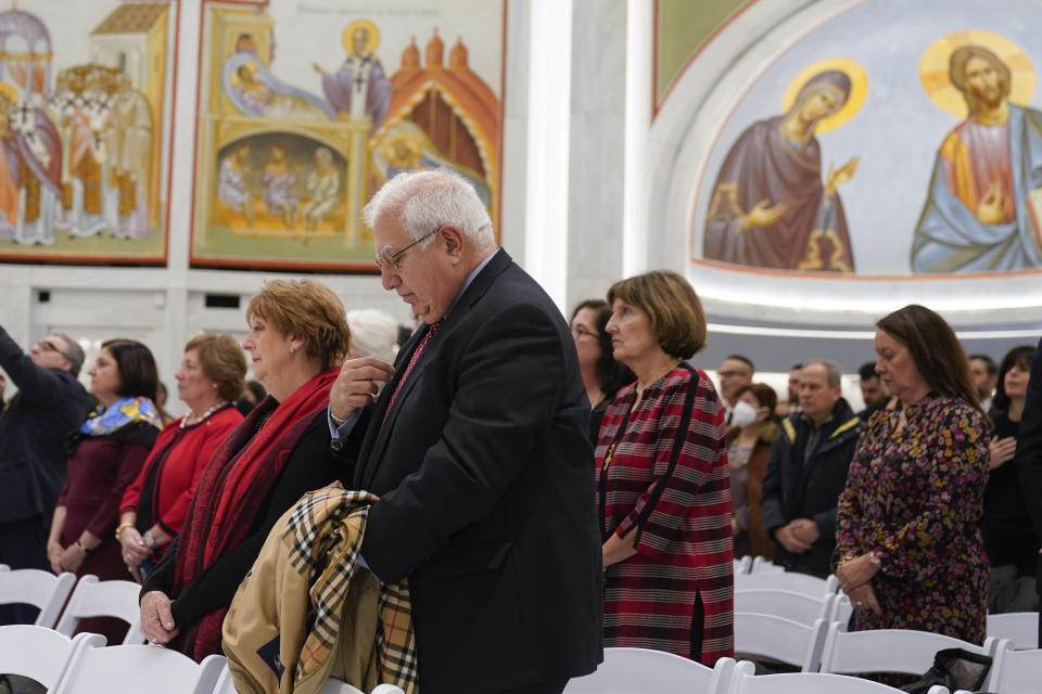 People attend a service at St. Nicholas Greek Orthodox Church in New York, Tuesday, Dec. 6, 2022. After a rebuilding process that lasted more than two decades, the Greek Orthodox church that was destroyed in the Sept. 11 attacks has reopened at the World Trade Center site. The St. Nicholas Greek Orthodox Church and National Shrine, designed by architect Santiago Calatrava, now overlooks the Trade Center memorial pools from an elevated park. (AP Photo/Seth Wenig)