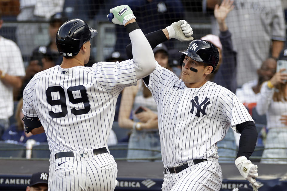 New York Yankees' Aaron Judge (99) is congratulated by Anthony Rizzo after hitting a home run during the first inning of the team's baseball game against the Chicago Cubs on Saturday, June 11, 2022, in New York. (AP Photo/Adam Hunger)