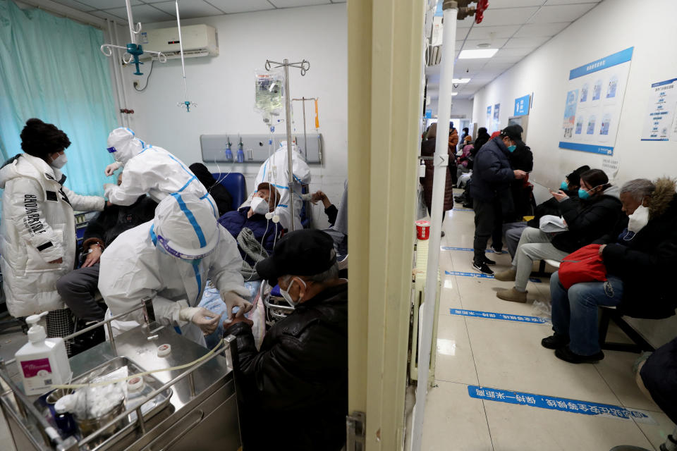 Medical workers in protective suits attend to patients at the fever clinic of China-Japan Friendship hospital, amid the coronavirus disease (COVID-19) outbreak in Beijing, China December 27, 2022. China Daily via REUTERS  ATTENTION EDITORS - THIS IMAGE WAS PROVIDED BY A THIRD PARTY. CHINA OUT.