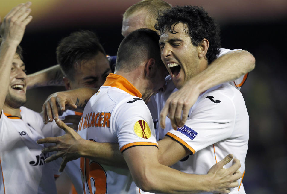 Valencia’s Paco Alcacer, center, celebrates with Dani Parejo, right, after scoring against Basel during the Europa League quarterfinal, second leg soccer match at the Mestalla stadium in Valencia, Spain, on Thursday, April 10, 2014. Valencia lost 3-0 in the first leg at Basel. (AP Photo/Alberto Saiz)