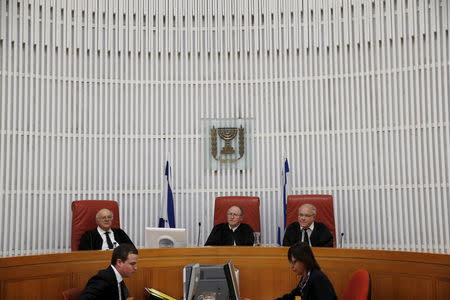 Judge Neal Hendel (R), vice president of the Supreme court, Judge Elyakim Rubinstein (C) and Judge Hanan Meltzer (L) are seen during a court session regarding the case of a hunger-striking Palestinian detainee, at the Supreme court in Jerusalem, August 19, 2015. REUTERS/Ronen Zvulun