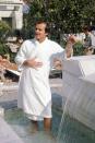 <p>Jack Nicholson wades in a fountain wearing a hotel robe and smoking a cigar while vacationing in the south of France for the Cannes Film Festival in 1974. </p>