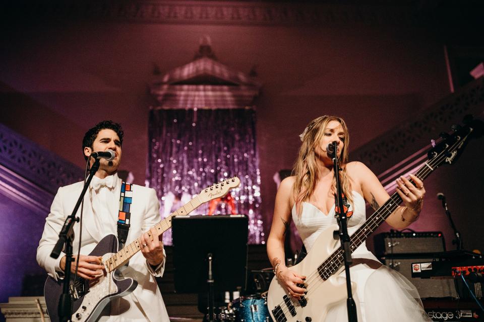 “One of the things we looked forward to the most was something we actually hid from nearly everyone at the wedding,” Darren explains. “The idea was to take an old tradition and turn it into something a lot more fun for us as bride and groom. I quickly put on a guitar and Mia put on a bass, and we exploded into ‘The Ballroom Blitz’ by Sweet to get the party started. We had a first song together as husband and wife—it was the coolest.”