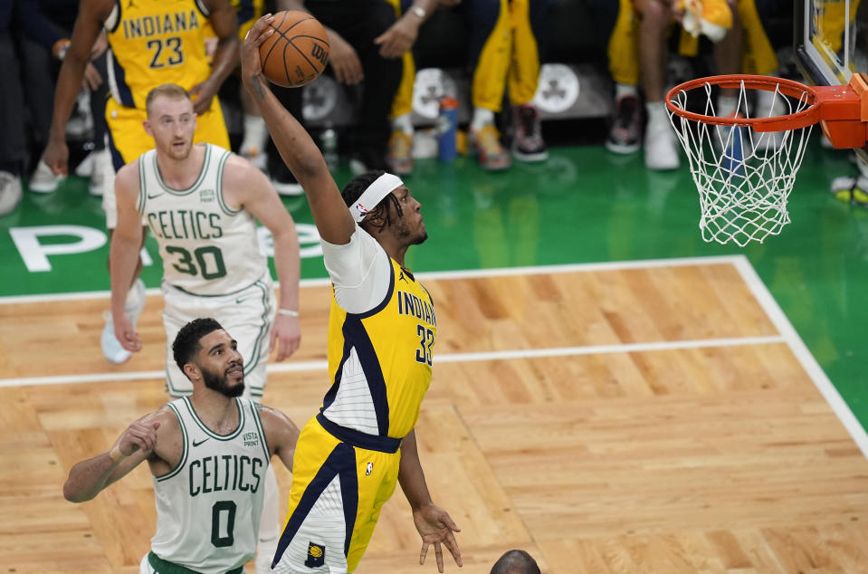 Indiana Pacers center Myles Turner (33) dunks the ball against Boston Celtics forward Jayson Tatum (0) during the second quarter of Game 1 of the NBA Eastern Conference basketball finals, Tuesday, May 21, 2024, in Boston. (AP Photo/Michael Dwyer)