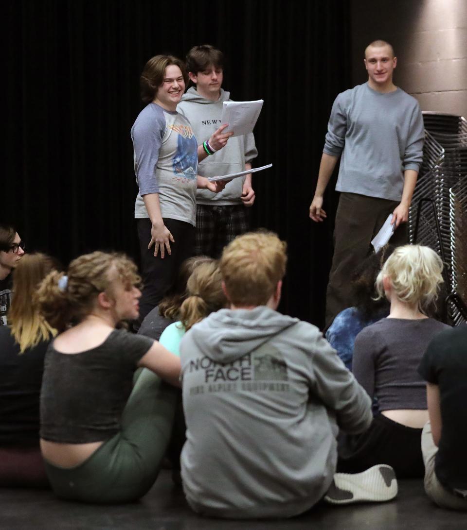 Kyle McFalls, left, goes over lines with castmates during rehearsal for "Tuck Everlasting" at Firestone high school.