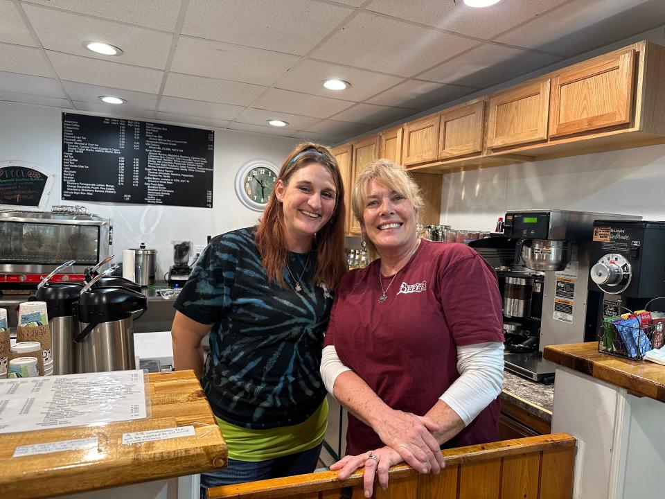 Surf City Coffee baristas Shantel Hoyle, left, and Andi Shapiro, right, serve up lattes with a smile because "life is too short for a crappy cup of coffee," which they say is a motto that goes around the coffee shop.