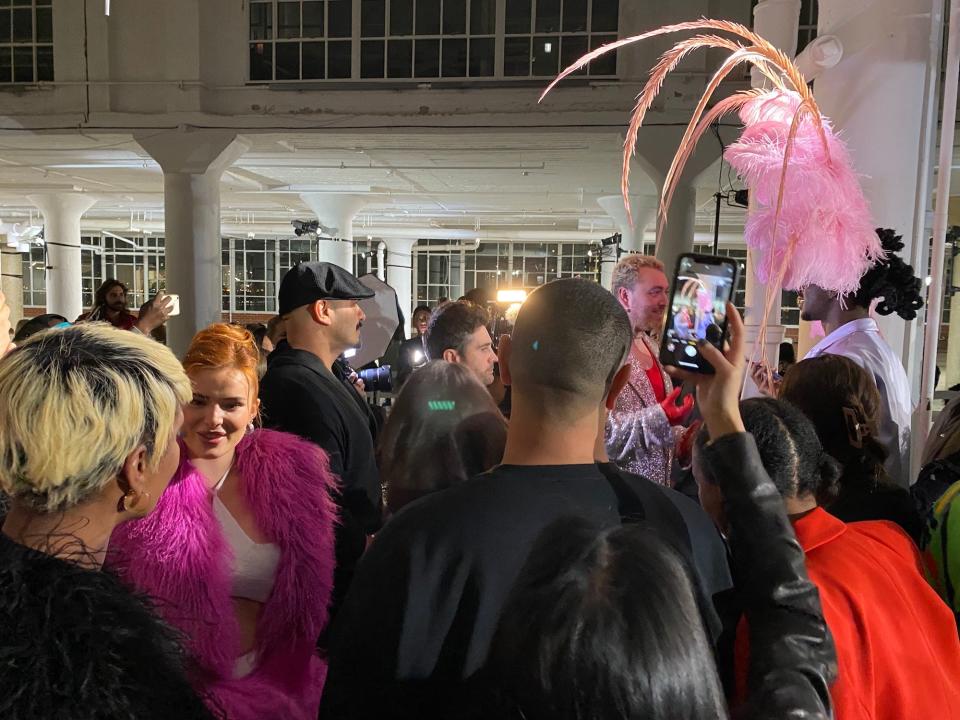 People gather around Sam Smith and Lil Nas X at Christian Cowan's Fall/Winter 2023 show.