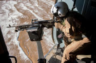 Afghan air force Sgt. Razeg, a gunner, fires an M-240 weapon from an Mi-17 Helicopter during a mission from Kabul, Afghanistan. The flight was a "check ride" mission, allowing an Afghan air force copilot and gunner to further train and qualify in their respective jobs (Dennis J. Henry Jr/USAF/Rex Features)