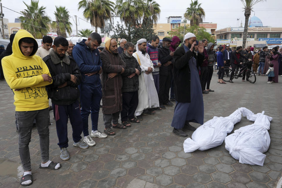 Palestinians mourn their relatives killed in the Israeli bombing of the Gaza Strip in Deir al Balah, Gaza Strip, on Tuesday, Jan. 2, 2024. (AP Photo/Adel Hana)