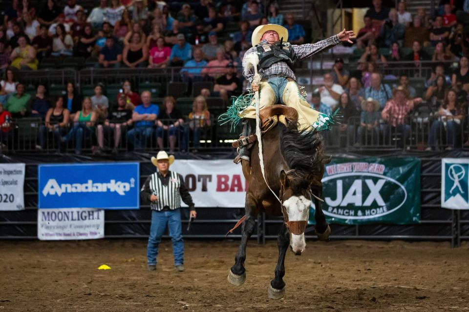 Saddle bronc rider Justin Hegwer holds onto Hi Flyer during the PRCA Rodeo in 2019 at the Budweiser Events Center in Loveland.