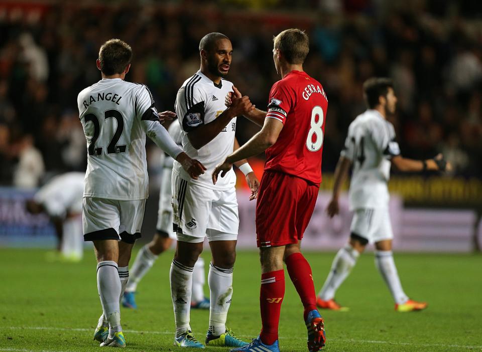 Swansea City's Ashley Williams (centre) and Liverpool's Steven Gerrard shake hands after the final whistle