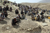 Afghans pray during the funeral of a victim who died in Wednesday's deadly suicide bombing that targeted a training class in a private building in the Shiite neighborhood of Dasht-i Barcha, in western Kabul, Afghanistan, Thursday, Aug. 16, 2018. The Afghan authorities have revised the death toll from the previous day's horrific suicide bombing in a Shiite area of Kabul to 34 killed. (AP Photo/Rahmat Gul)