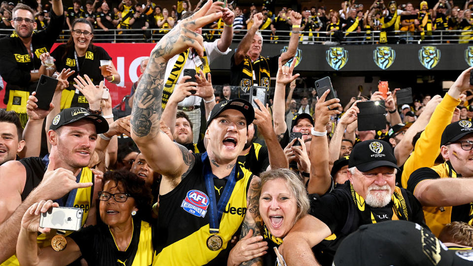 Dustin Martin is seen here celebrating a grand final win with fans.