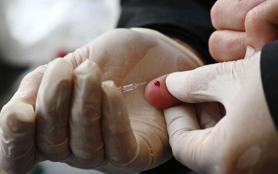 A person undergoes a fingerprick coronavirus test - Frederick Florin/ AFP