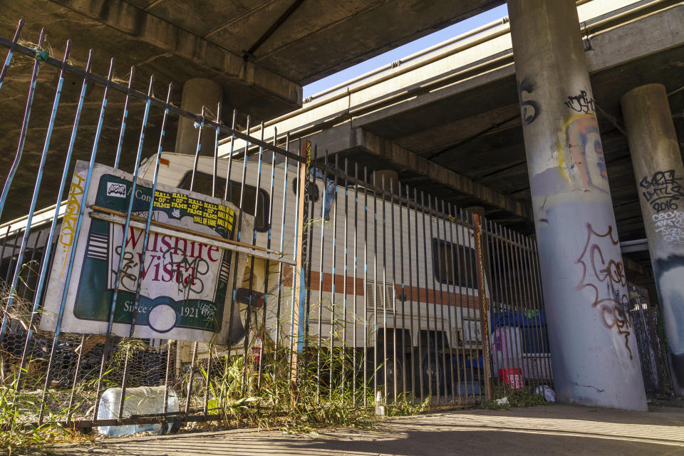 A mobile home is parked under the Interstate 10 freeway in Los Angeles, Thursday, Dec. 7, 2023. (AP Photo/Damian Dovarganes)