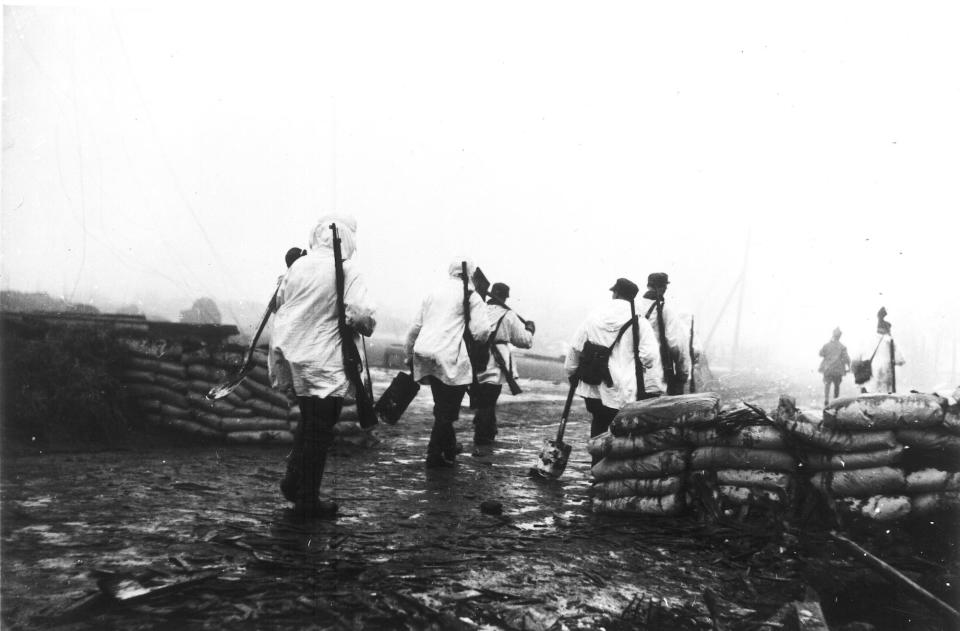 Finnish troops wearing their white tunics over their uniforms as camouflage