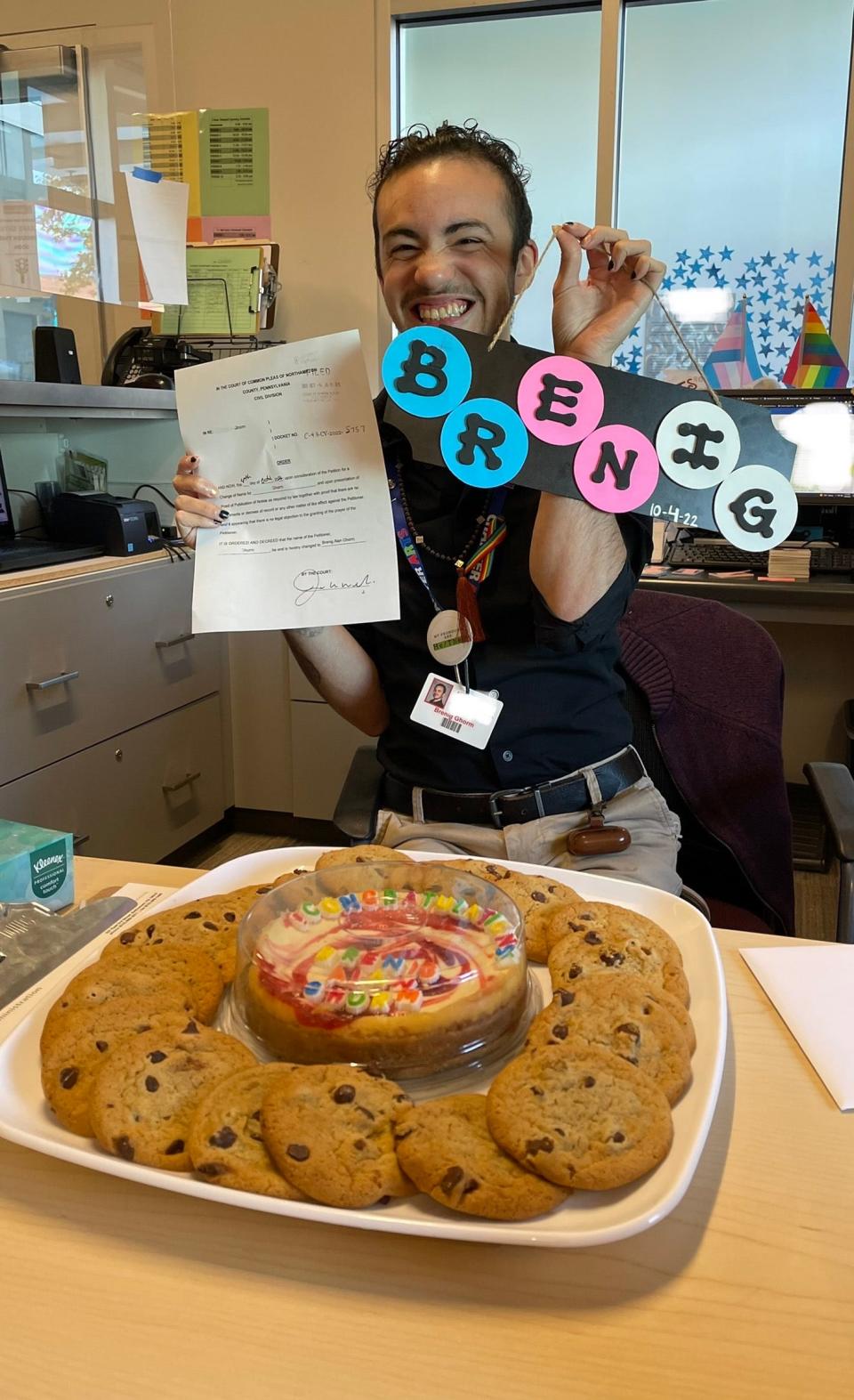 Brenig Ghorm, Northampton County, poses during a celebration his coworkers held after his legal name change in October. Many transgender and nonbinary Pennsylvanians face barriers in the state's name change process that advocates say could be fixed with a package of Senate bills introduced this year.