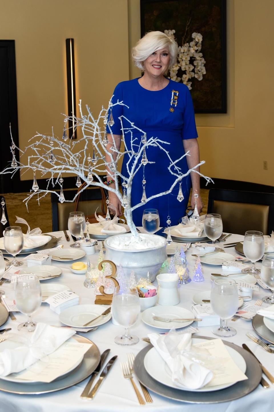Susan Erichsen stands in front of her tablescape