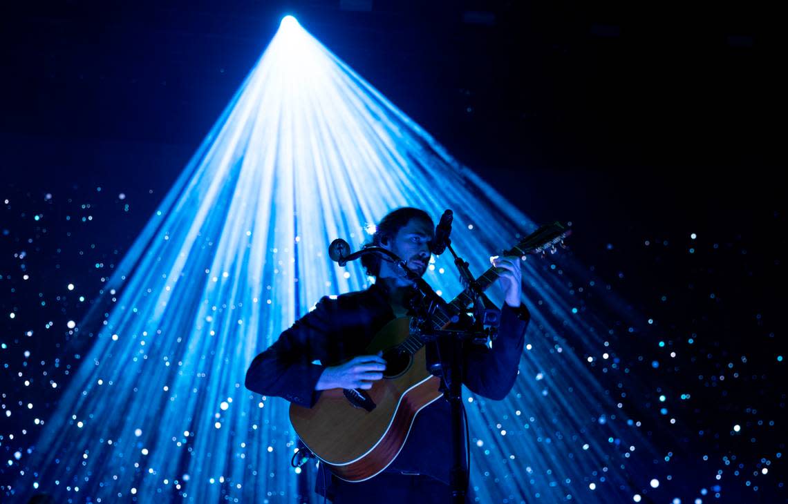 A cascade of blue and white light envelopes Hozier ias he opens his concert at Coastal Credit Union Music Park at Walnut Creek in Raleigh, N.C., Saturday night, April 20, 2024.