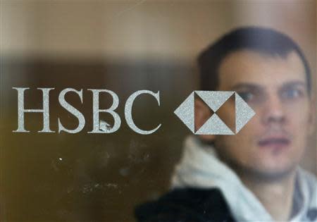 A man leaves a branch of the HSBC bank at Hayes in west London February 24, 2014. REUTERS/Luke MacGregor