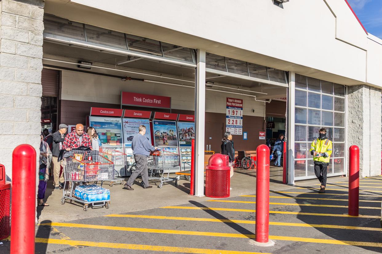 people with shopping carts filled with groceries