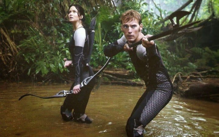 A man and a woman hunt in The Hunger Games: Catching Fire.