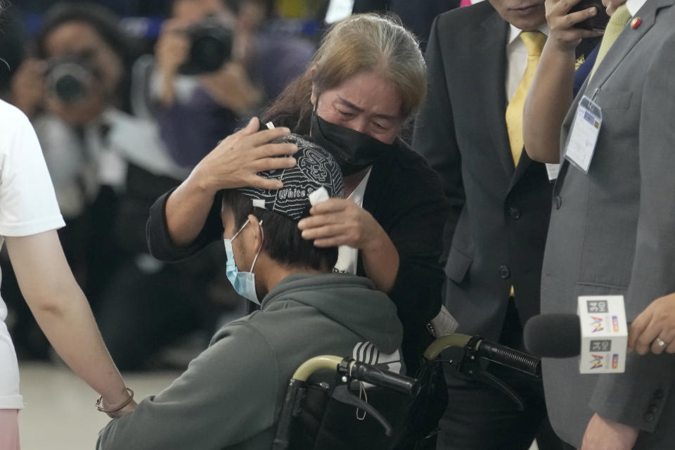 A relative hugs a Thai overseas worker who was evacuated from Israel, on his arrival at Suvarnabhumi International Airport in Samut Prakarn Province, Thailand, Thursday, Oct. 12, 2023. The first Thai nationals evacuated since the latest war between Israel and Hamas returned home Thursday. (AP Photo/Sakchai Lalit)