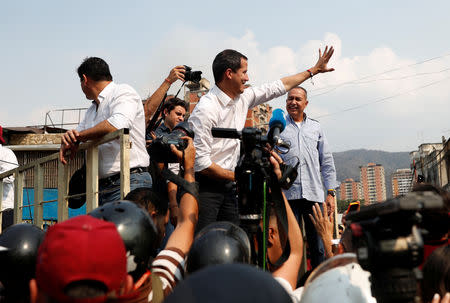 Venezuelan opposition leader Juan Guaido, who many nations have recognized as the country's rightful interim ruler, greets his supporters as he takes part in a protest against Venezuelan President Nicolas Maduro's government in Caracas, Venezuela, April 10, 2019. REUTERS/Carlos Garcia Rawlins