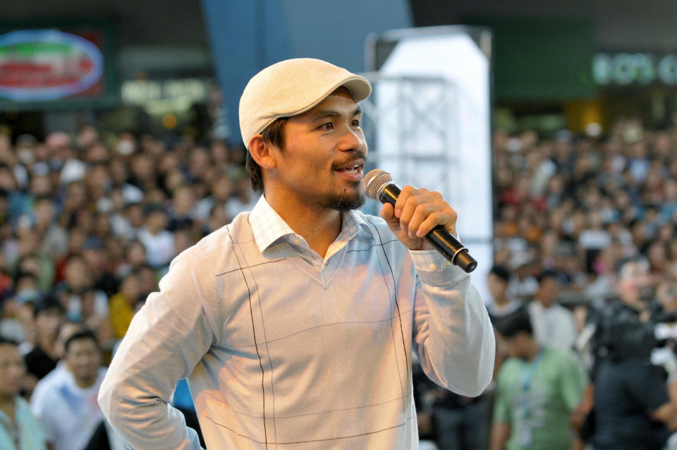 Philippine boxing champ Manny Pacquiao sings at his victory concert at a shopping mall in Manila