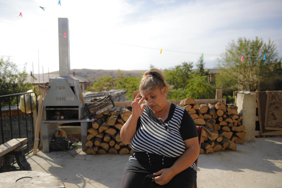 Azime Ali Topchu, 48, a Bulgarian Roma woman, gestures during an interview with the Associated Press in a village on the outskirts of Burgas, Bulgaria, Monday, Sept. 28, 2020. Human rights activists and experts say local officials in several countries with significant Roma populations have used the pandemic to unlawfully target the minority group, which is Europe's largest and has faced centuries of severe discrimination. Topchu said that the police-enforced lockdown of her village in Burgas, on Bulgaria's Black Sea Coast, made her family "really sad." (AP Photo/Vadim Ghirda)