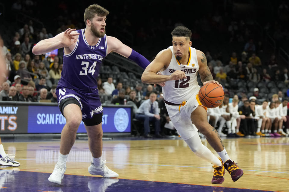 Arizona State guard Jose Perez (12) drives on Northwestern center Matthew Nicholson during the first half of an NCAA college basketball game Wednesday, Dec. 20, 2023, in Phoenix. (AP Photo/Rick Scuteri)