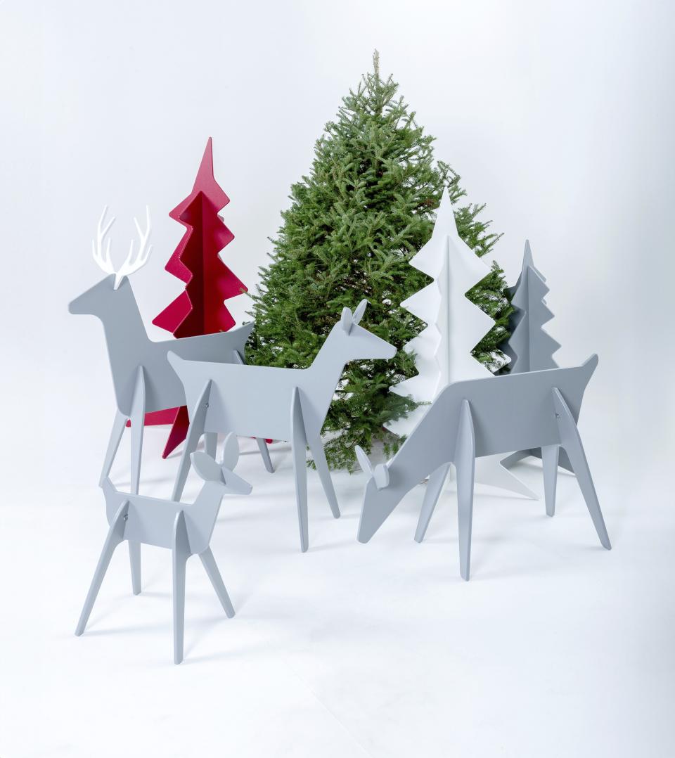 This image provided by Loll Designs shows minimalist contemporary wooden Christmas trees and reindeer, which fit together with simple slots, and are easy to stash under a bed or behind a cupboard. (Loll Designs via AP)