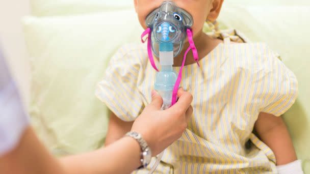 PHOTO: A nurse administers inhalation therapy to a pediatric patient in a stock photo.  (Blanscape/Shutterstock)