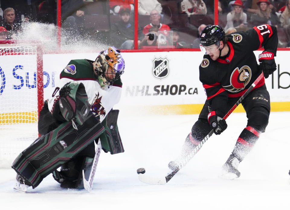 Arizona Coyotes goaltender Karel Vejmelka (70) stops a shot from Ottawa Senators right wing Drake Batherson (19) during the second period of an NHL hockey game in Ottawa, Ontario on Saturday, Oct. 22, 2022. (Sean Kilpatrick/The Canadian Press via AP)