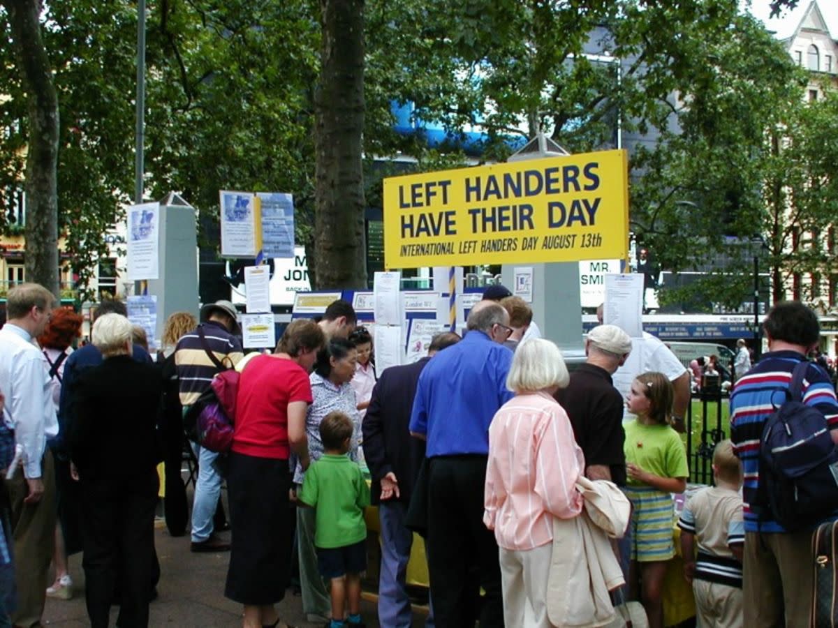 People celebrating International Lefthanders Day in Leicester Square, London on August 13th, 2002