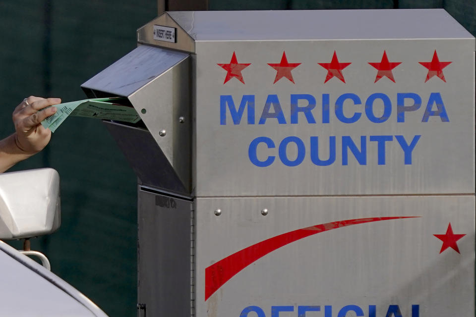 A voter casts their ballot at a secure ballot drop box at the Maricopa County Tabulation and Election Center in Phoenix, Tuesday, Nov. 1, 2022. (AP Photo/Matt York)