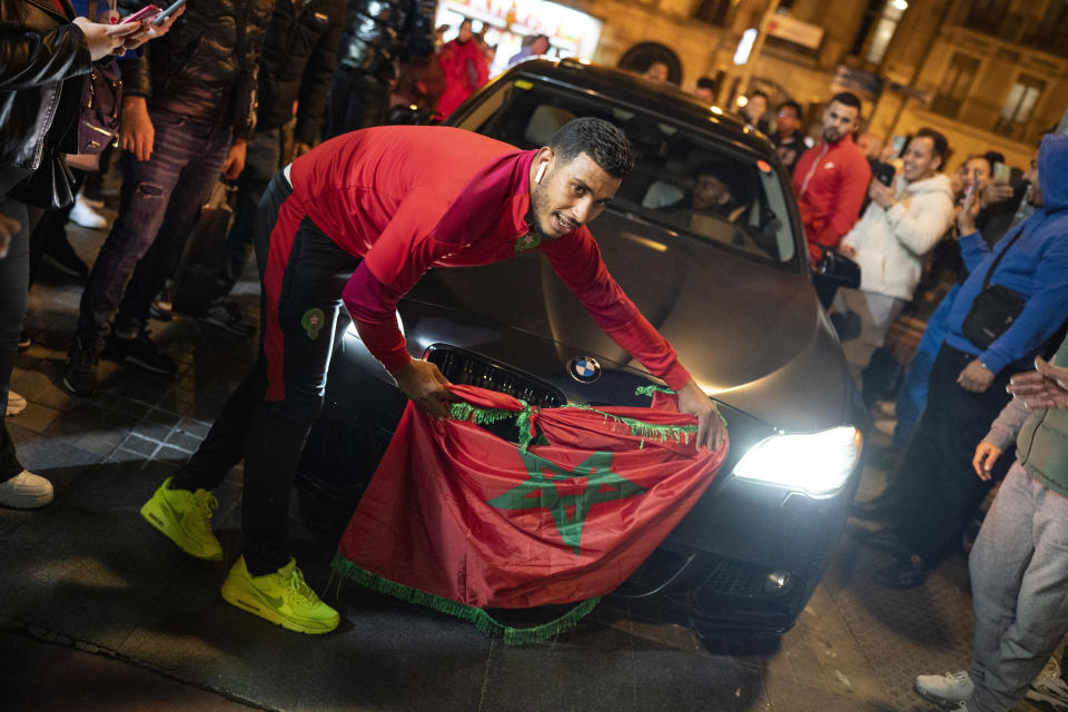 Morocco fans celebrate in Barcelona, Spain, after defeating Portugal in the World Cup quarterfinal soccer match played in Qatar, Saturday, Dec. 10, 2022. (AP Photo/Joan Mateu Parra)