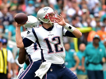 Dec 9, 2018; Miami Gardens, FL, USA; New England Patriots quarterback Tom Brady (12) throws a pass against the Miami Dolphins during the first half at Hard Rock Stadium. Mandatory Credit: Steve Mitchell-USA TODAY Sports