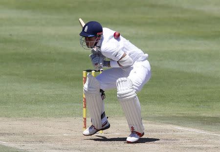 England's Alex Hales is hit by a short ball during the second cricket test match against South Africa in Cape Town, South Africa, January 2, 2016. REUTERS/Mike Hutchings