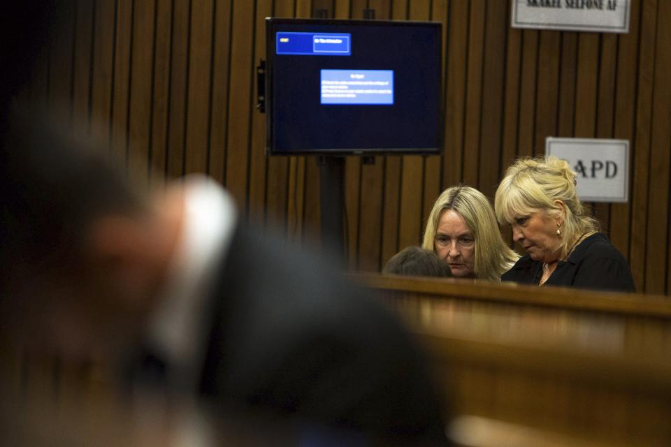 Reeva Steenkamp's mother June (back L) sits in the public gallery as Olympic and Paralympic track star Oscar Pistorius takes his seat in the North Gauteng High Court in Pretoria, March 17, 2014. Pistorius is on trial for murdering his girlfriend Steenkamp at his suburban Pretoria home on Valentine's Day last year. REUTERS/Daniel Born/Pool (SOUTH AFRICA - Tags: SPORT CRIME LAW ATHLETICS)