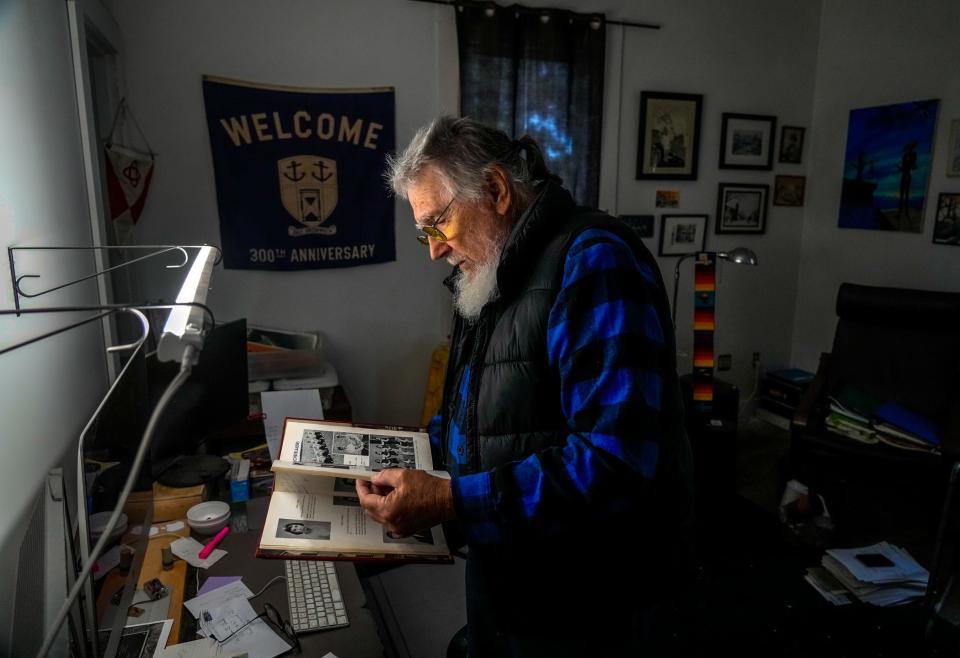 Alan Clarke looks for more pictures of his friend Gwen Bowers in an East Greenwich High School yearbook.