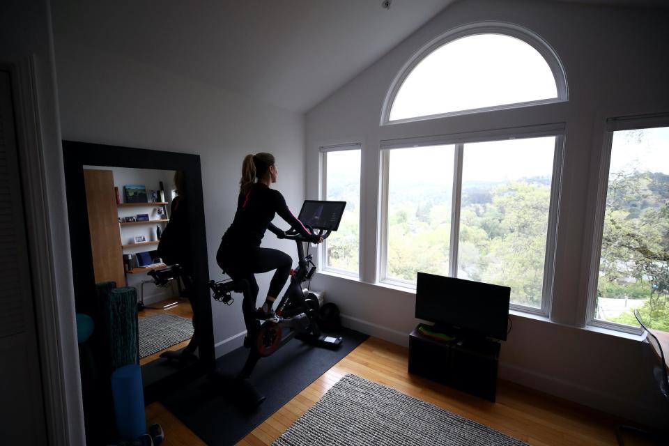 Cari Gundee rides her Peloton exercise bike at her home on April 06, 2020 in San Anselmo, California. More people are turning to Peloton due to shelter-in-place orders because of the coronavirus (COVID-19). Peloton stock has continued to rise over recent weeks even as most of the stock market has plummeted: Ezra Shaw/Getty Images