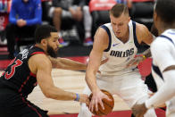 Toronto Raptors guard Fred VanVleet (23) knocks the ball away from Dallas Mavericks forward Kristaps Porzingis (6) during the second half of an NBA basketball game Monday, Jan. 18, 2021, in Tampa, Fla. (AP Photo/Chris O'Meara)