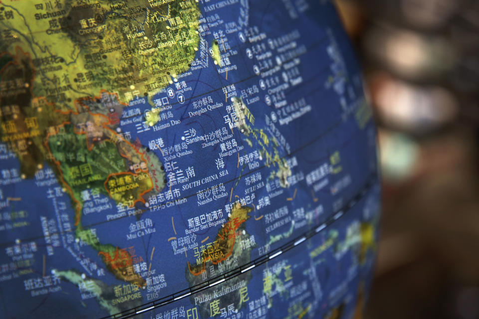 FILE - In this July 13, 2018, file photo, a globe shows the islands on the South China Sea with nine-dash line claims under Chinese territory on display at a bookstore in Beijing. Southeast Asian nations are expected to welcome an initial negotiating draft of a nonaggression pact with China on the South China Sea, but critics warn that the protracted talks provide a diplomatic cover for Beijing's tenacious aggression in the disputed waters. Four days of annual summitry in Singapore starts Wednesday, Aug. 1, 2018. (AP Photo/Andy Wong, File)