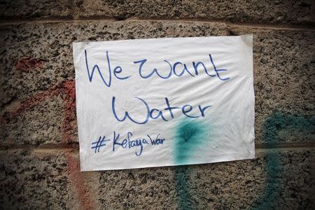 A sign is seen on a wall during a protest against a Saudi blockade of Yemen's ports, outside the United Nations' offices in Sanaa, Yemen October 19, 2015. REUTERS/Khaled Abdullah