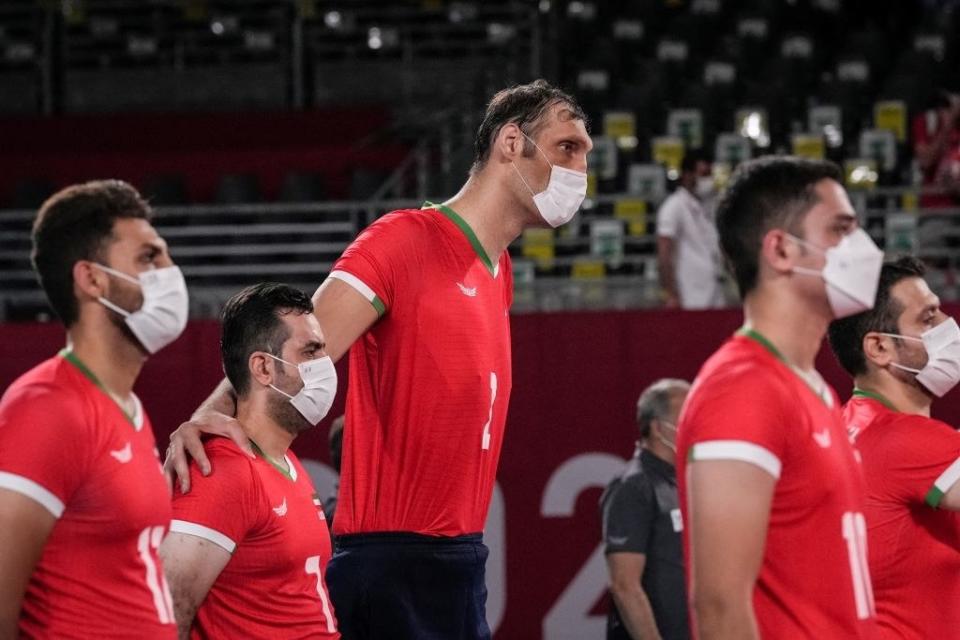 Morteza Mehrzad Selakjani (center) stands with teammates