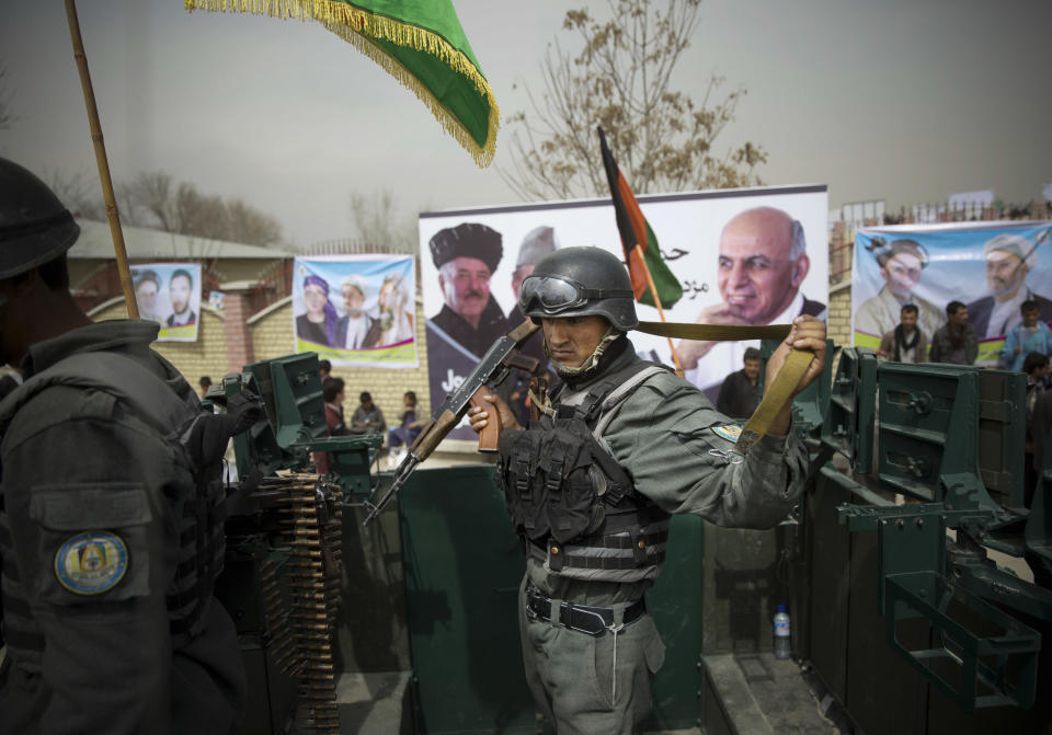 Afghan police men secure the area as Afghan presidential candidate Ashraf Ghani Ahmadza arrived for an election campaign rally to the stadium in Kabul, Afghanistan, Tuesday, April 1, 2014. Elections will take place on April 5, 2014. (AP Photo/Anja Niedringhaus)