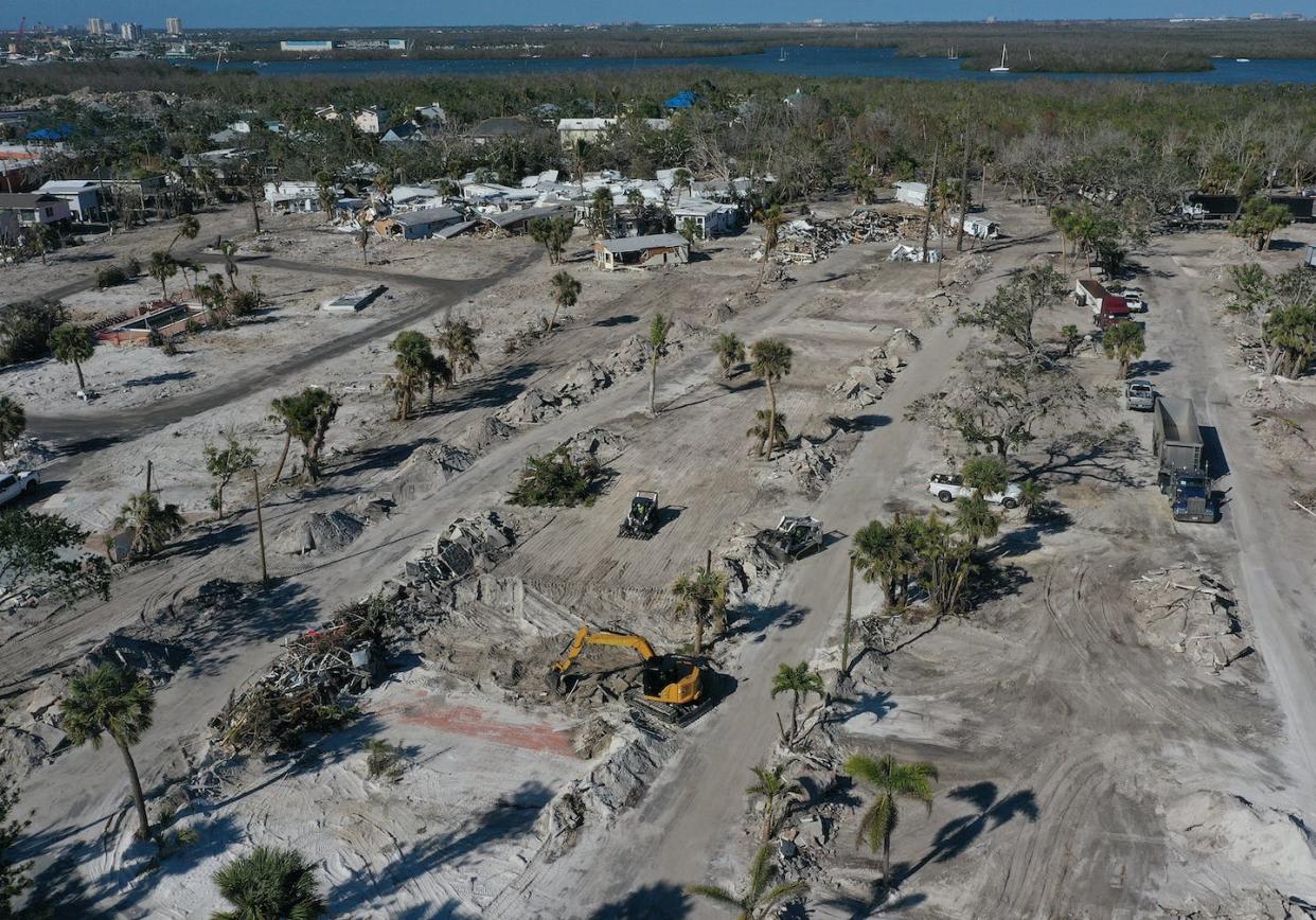 Crews clear lots of destroyed homes in Fort Myers Beach, Fla., in February 2022, four months after Hurricane Ian. <a href="https://www.gettyimages.com/detail/news-photo/in-this-aerial-view-construction-crews-clear-lots-of-homes-news-photo/1459509524" rel="nofollow noopener" target="_blank" data-ylk="slk:Joe Raedle/Getty Images;elm:context_link;itc:0;sec:content-canvas" class="link ">Joe Raedle/Getty Images</a>